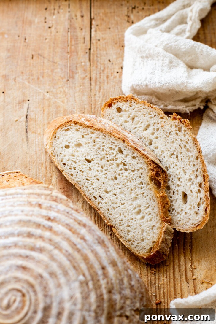 A cross-section of a perfectly baked gluten-free bread, showing its open crumb structure and the beautiful texture achieved with psyllium husk.
