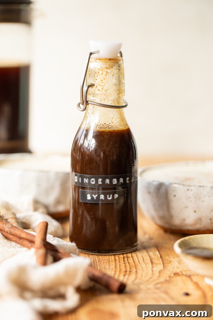 Handcrafted Gingerbread Elixir 2 Delicious Homemade Gingerbread Syrup in a glass bottle, perfect for healthier gingerbread lattes, pancakes, and desserts, sweetened with maple syrup and coconut sugar.