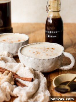 Homemade Gingerbread Syrup in a glass jar with a white label, ready for use.
