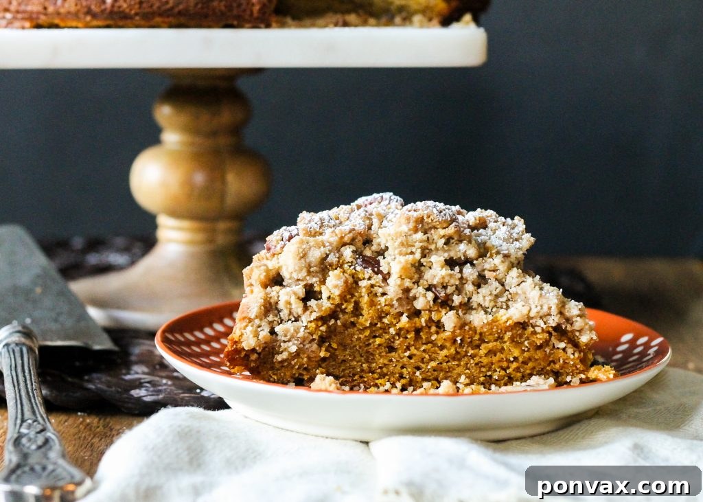 A close-up view of the golden-brown, textured crumb topping on the Pumpkin Crumb Cake, highlighting its generous thickness.