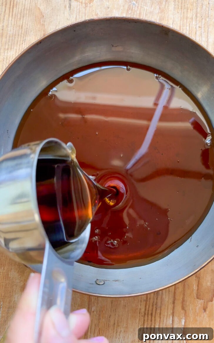 Seasonal Spice Infusion 5 Orange zest and spices in a saucepan with liquid