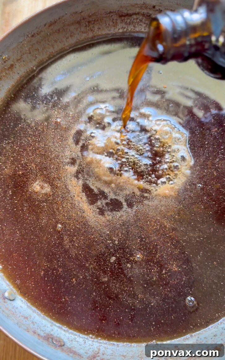 Seasonal Spice Infusion 8 Straining winter spice syrup into a jar