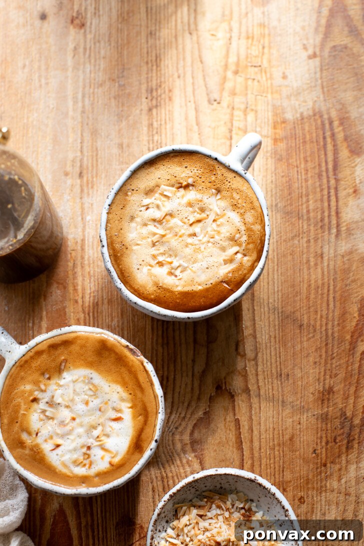 Tropical Coconut Elixir 4 A saucepan on a stove with coconut sugar, water, and coconut flakes simmering gently, creating the homemade coconut syrup.