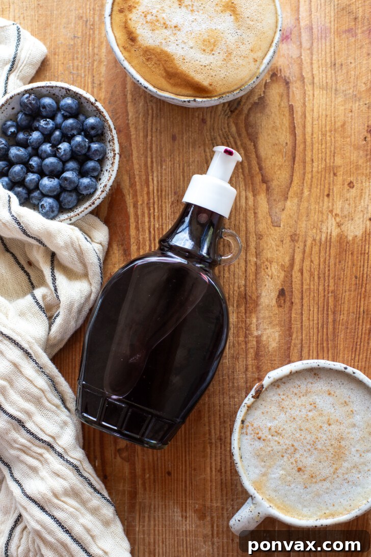 Sweet Blueberry Elixir: Elevate Your Lattes, Cocktails, and Culinary Creations 4 A close-up shot of the raw ingredients for blueberry syrup in a small saucepan, featuring fresh or frozen blueberries, water, and maple syrup, ready to be simmered.