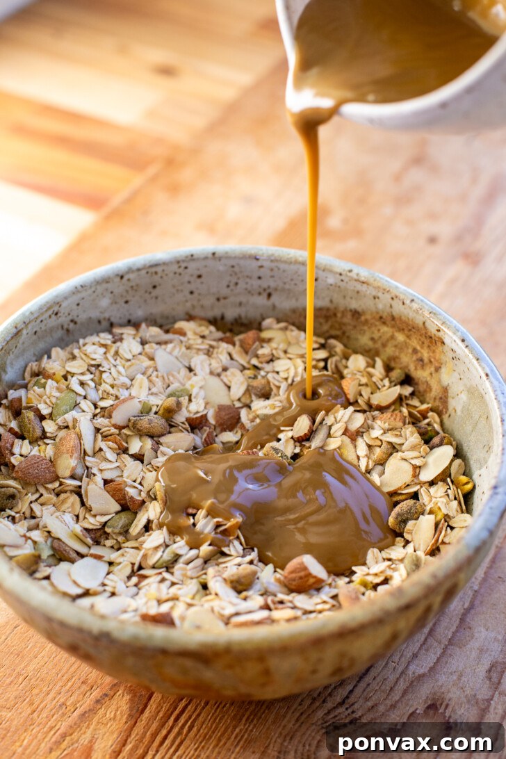 Wet ingredients for savory granola being whisked in a separate bowl.