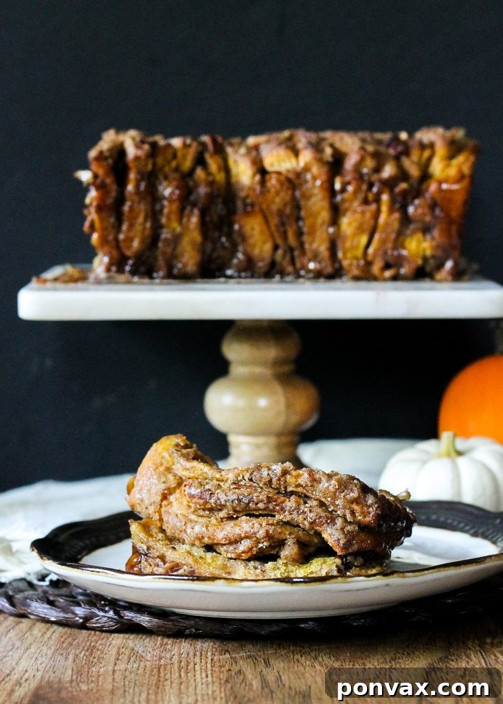 A delicious slice of Pumpkin Pecan Cinnamon Sugar Pull Apart Bread with a fork, ready to eat.
