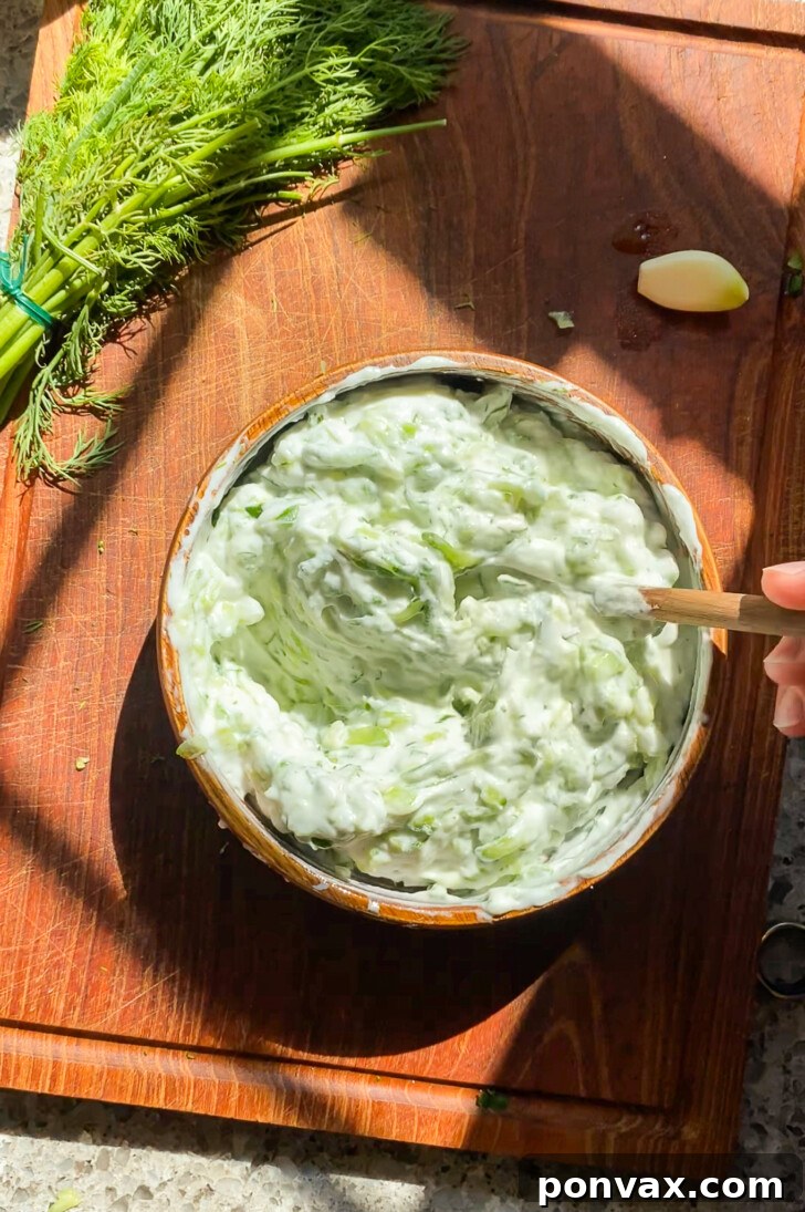 Dairy-Free Tzatziki Delight 10 Platter with vegan tzatziki sauce, fresh vegetables, and flatbread for dipping.