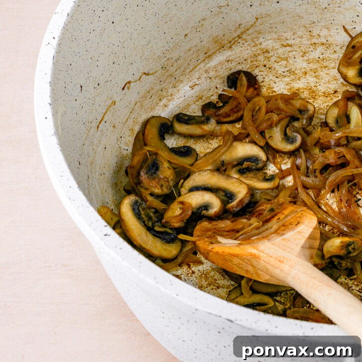 Wholesome One-Pot White Bean Mushroom Stew 7 Garlic and thyme added to the sautéed mushrooms and onions in the pot.