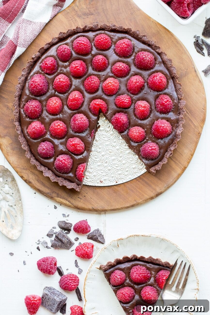 This No-Bake Raspberry Chocolate Tart is incredibly easy to make, featuring a rich chocolate ganache and fresh raspberries.