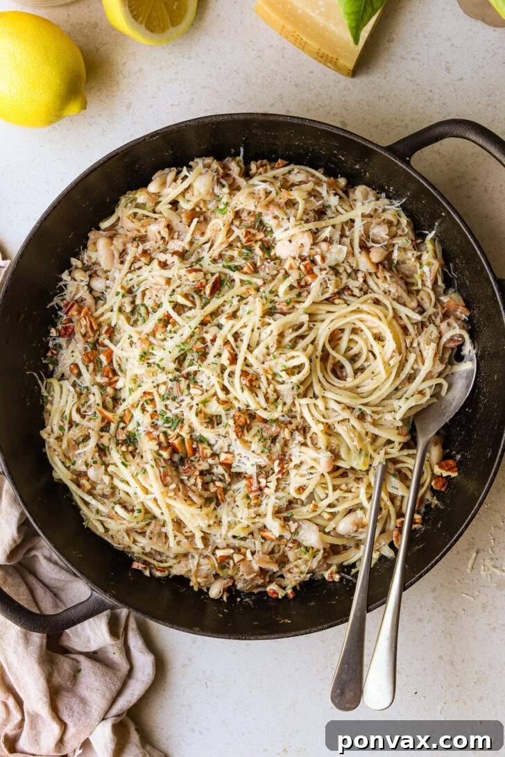 A close-up shot of Caramelized Cabbage Pasta with fresh chives and vegan parmesan, highlighting its rich, golden hues and comforting appeal.