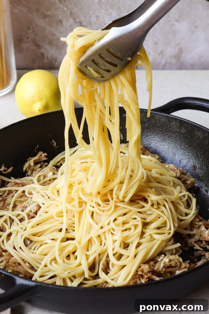 The combined Caramelized Cabbage Pasta, showcasing its creamy texture and rich color, mixed with white beans and ready for garnish.