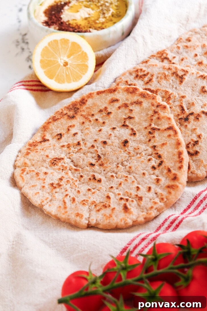 Freshly baked gluten-free sourdough flatbread on a rustic surface.