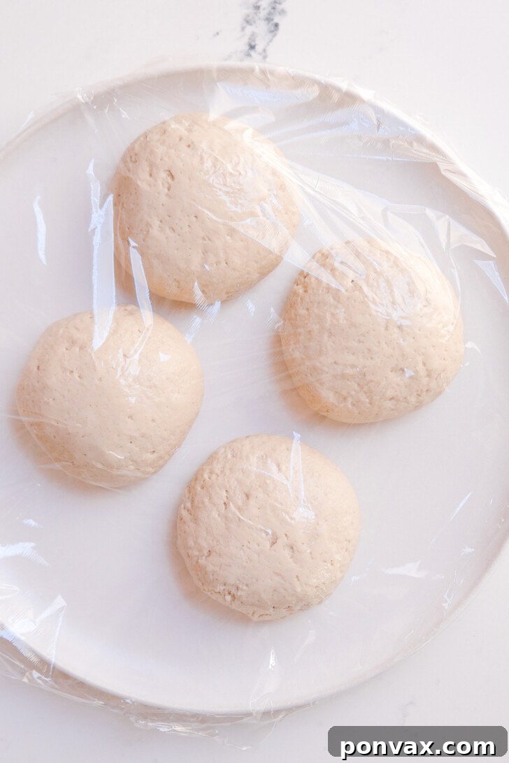 Step 5: Dividing the risen dough into four equal portions, ready for shaping.