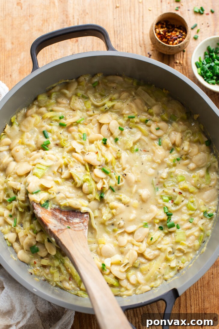 Silky Butter Beans with Zesty Leeks and Lemon 2 Creamy Butter Beans with Leeks & Lemon, served in a bowl, garnished with fresh herbs.