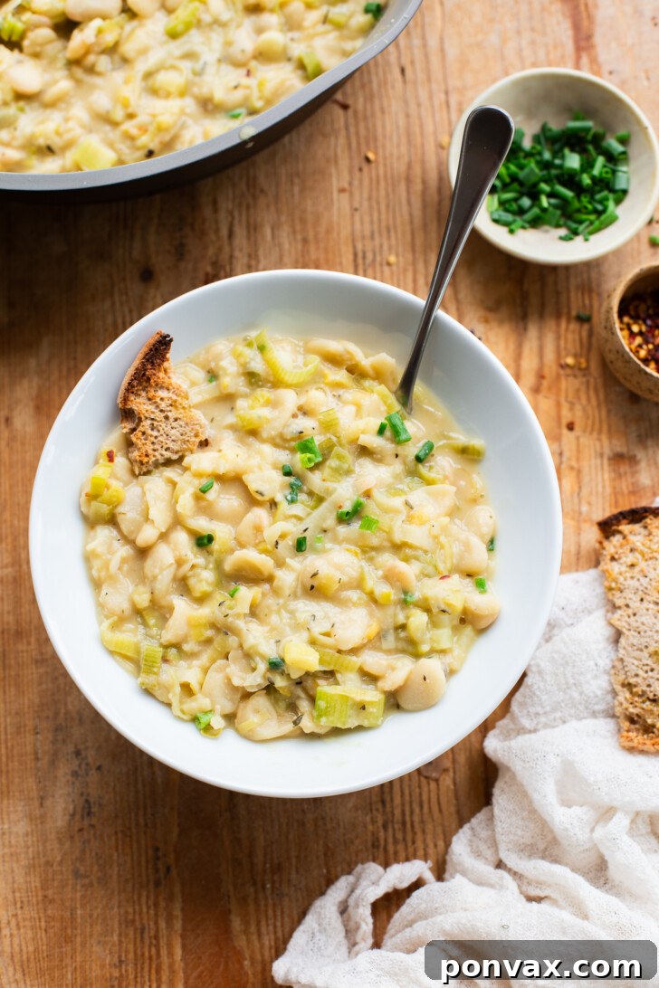 Silky Butter Beans with Zesty Leeks and Lemon 6 A serving of Creamy Butter Beans with Leeks & Lemon, with a side of toasted bread.