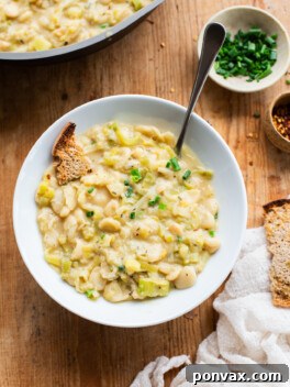 Silky Butter Beans with Zesty Leeks and Lemon 7 Creamy Butter Beans with Leeks & Lemon, served in a bowl, garnished with fresh herbs.