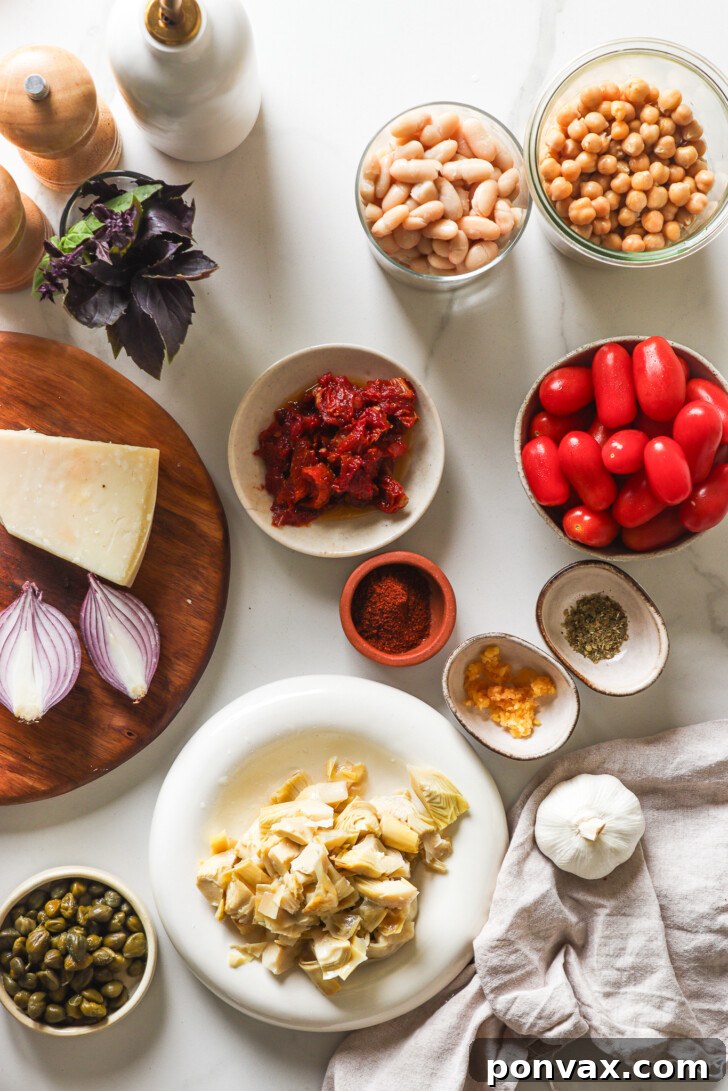 Ingredients in bowls to make a mediterranean bean salad.