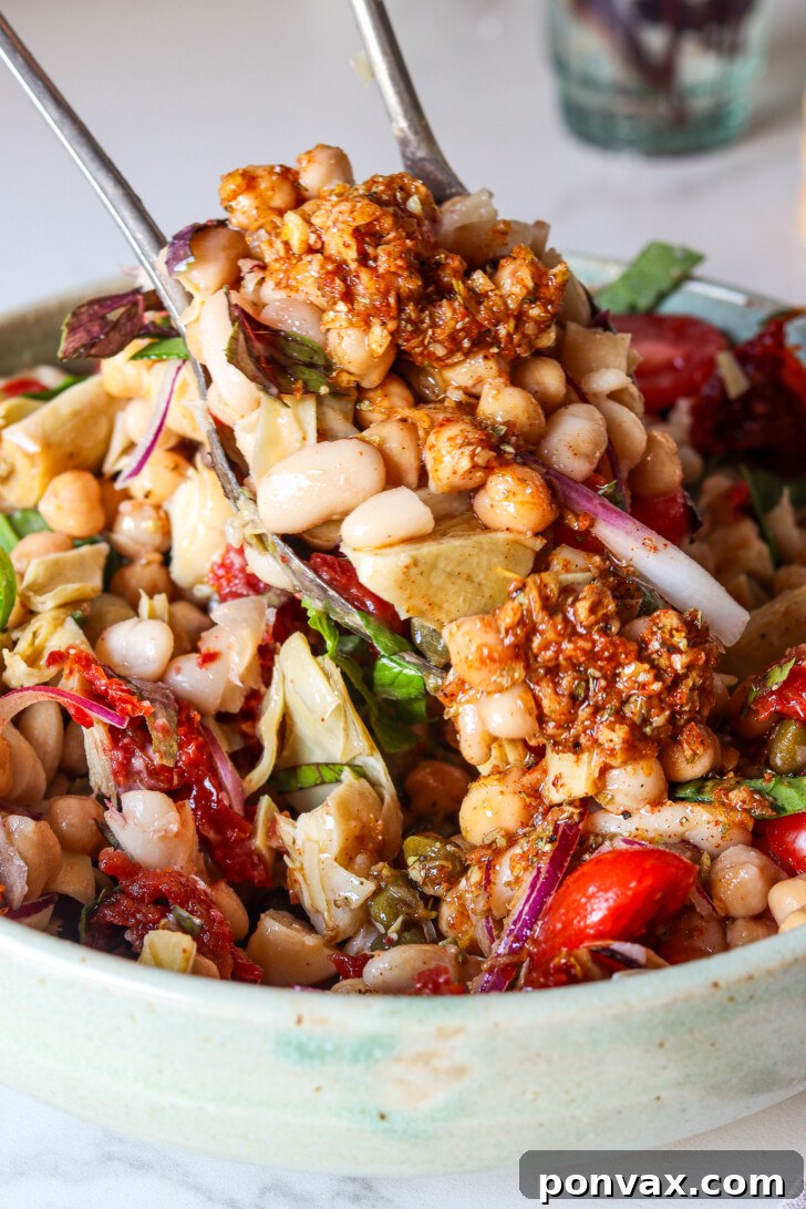 Mediterranean bean salad with olive oil-drizzled bread on the side.