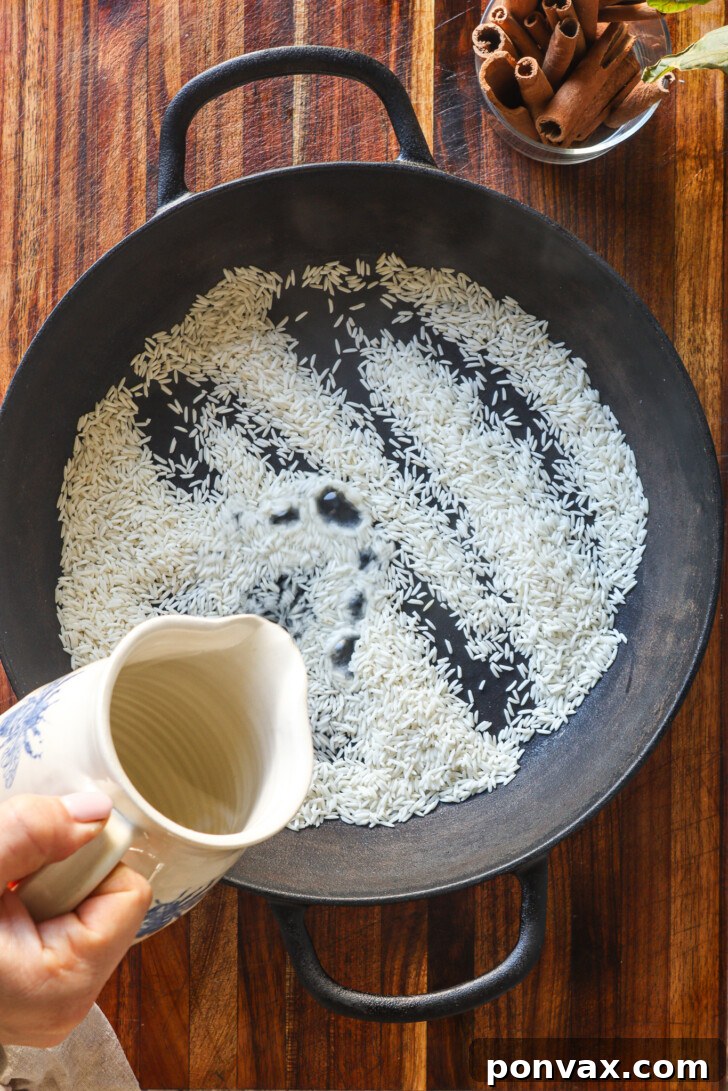 Cinnamon sticks and toasted rice being combined in a saucepan with water and sugar.