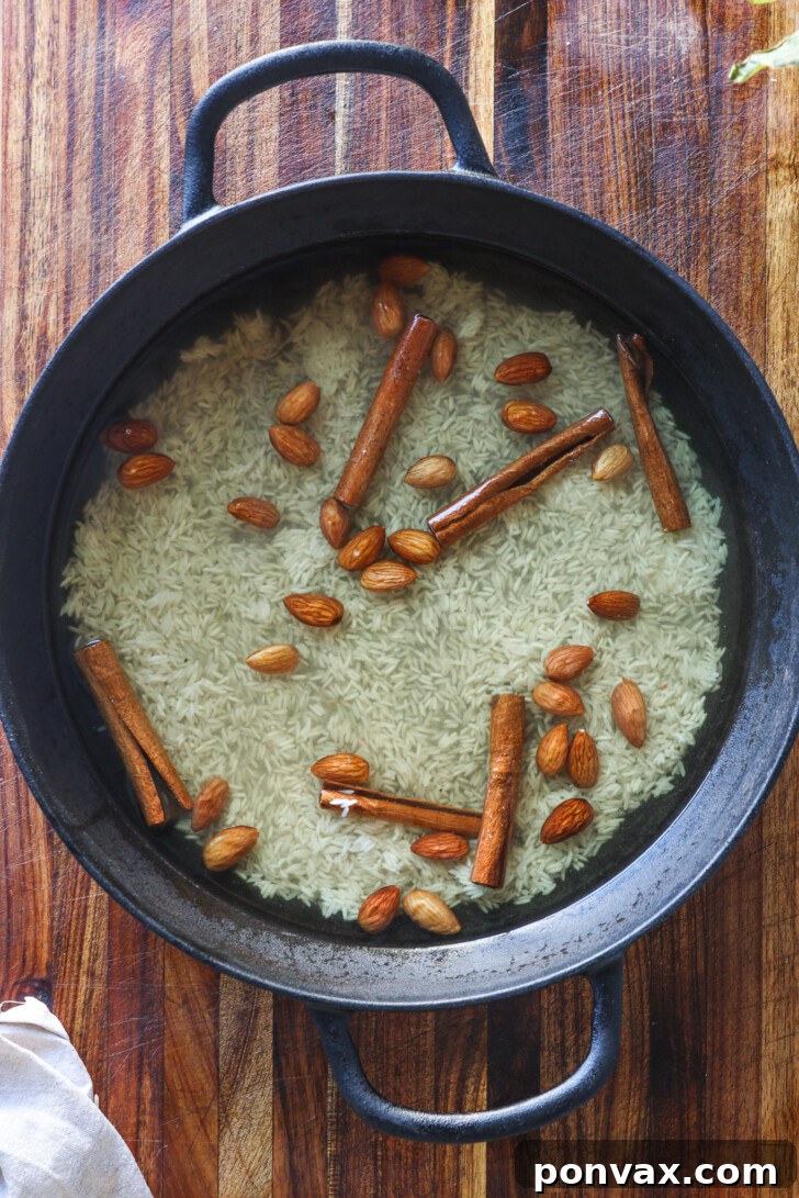 Close-up of the syrup mixture simmering gently on the stove, infused with rice and cinnamon.