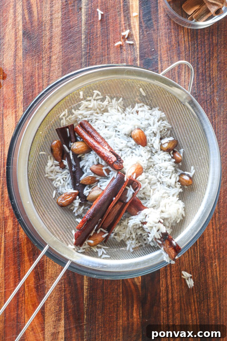 Strained horchata syrup in a bowl, ready to be bottled.