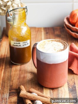 Delicious Sugar-Free Pumpkin Spice Syrup in a bottle next to a festive pumpkin