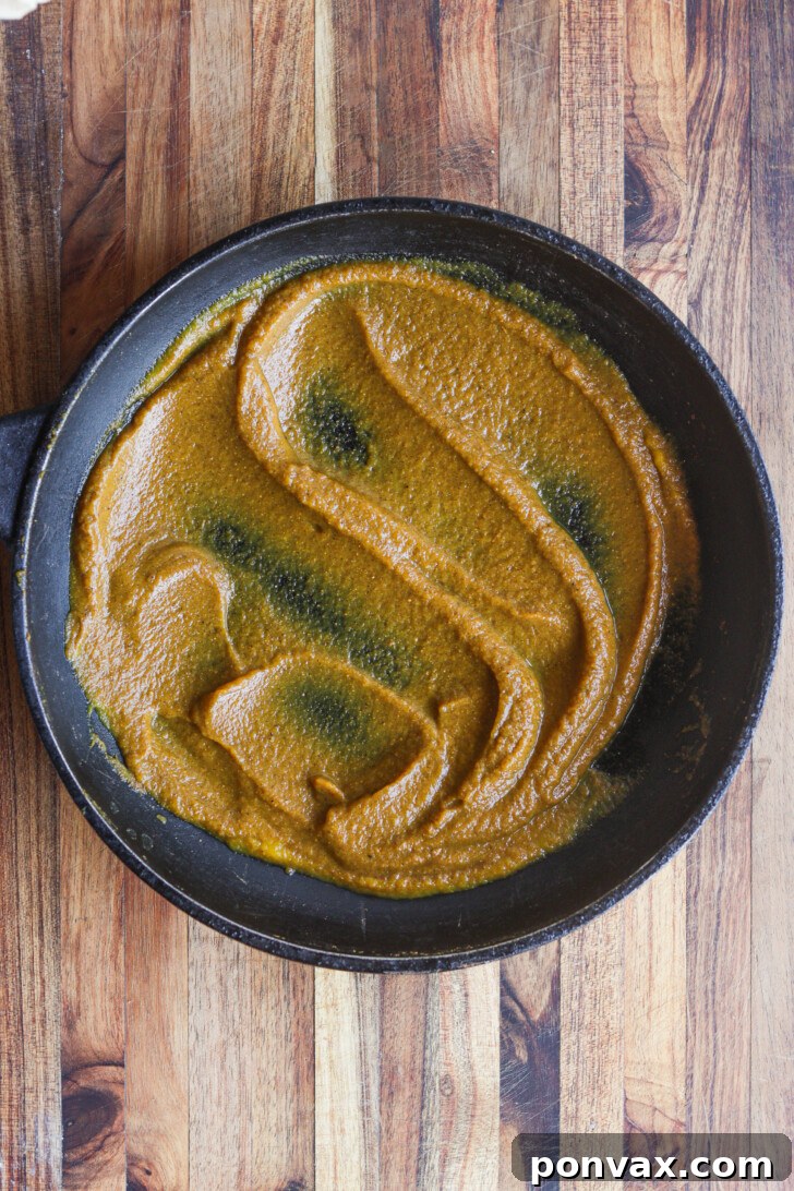 Step 1: Pumpkin puree and spices combined in a saucepan on the stove.