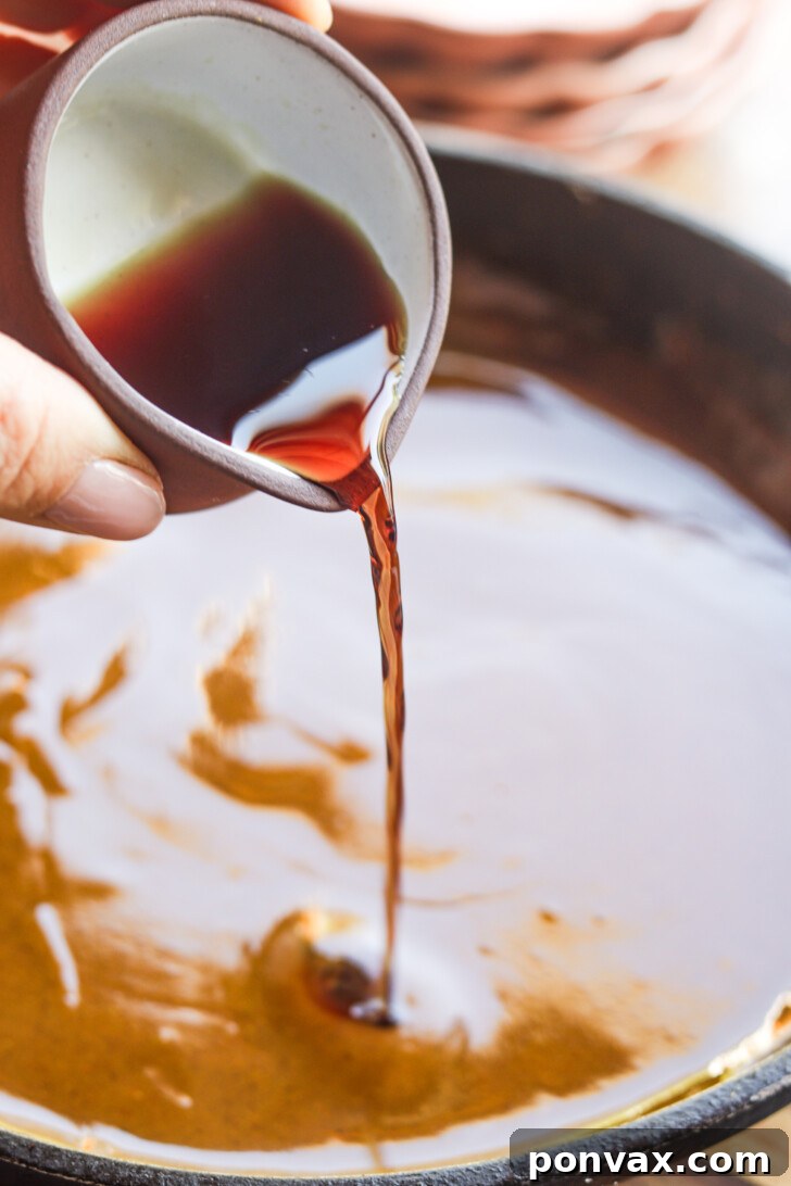Step 2: Stirring pumpkin and spices to cook off the raw flavor.