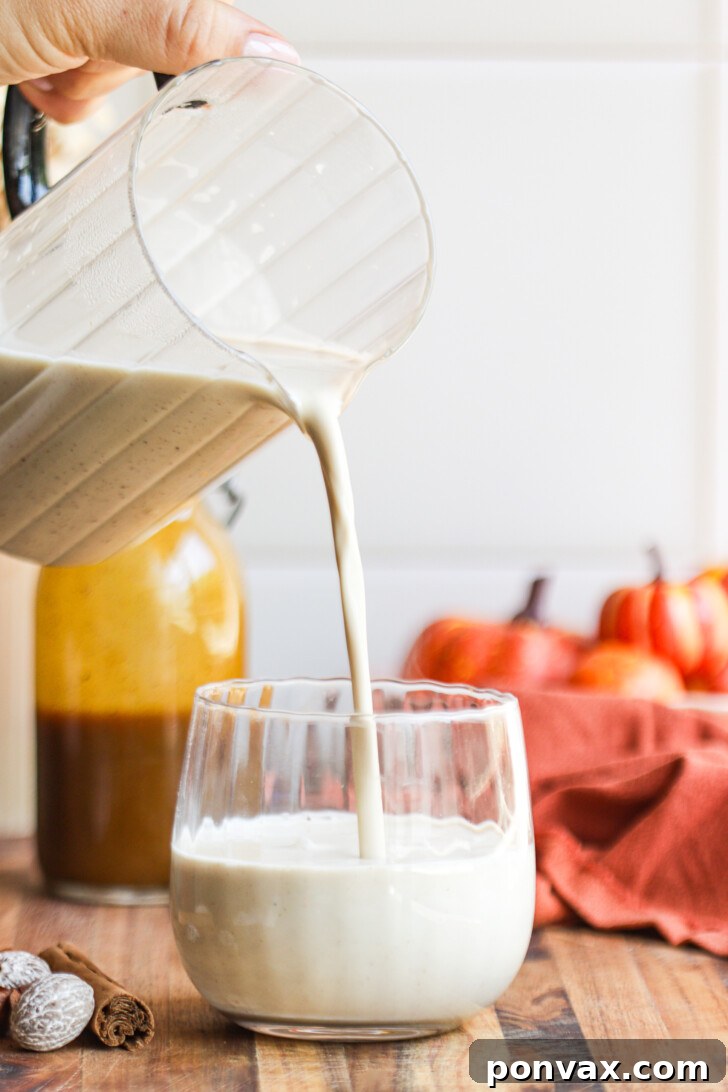 A glass bottle of homemade sugar-free pumpkin spice syrup with a label, ready for use.