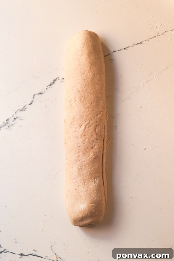 Irresistible Gluten-Free Sourdough Cinnamon Buns 14 Slicing the dough log into individual cinnamon rolls.