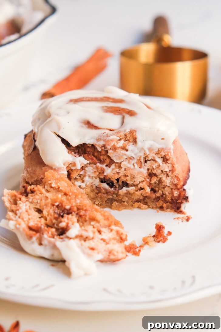 Irresistible Gluten-Free Sourdough Cinnamon Buns 4 Glazed gluten-free sourdough cinnamon rolls arranged artfully, ready to be served.