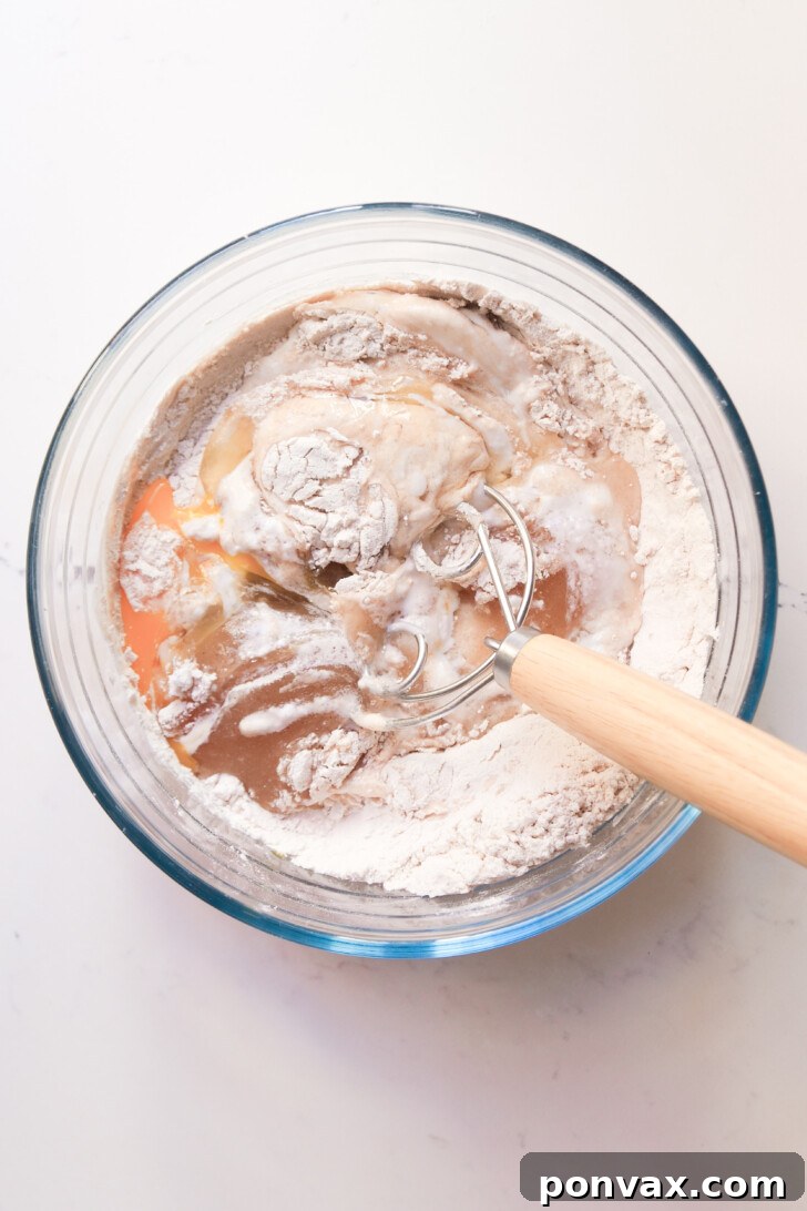 Irresistible Gluten-Free Sourdough Cinnamon Buns 8 Gluten-free sourdough dough being kneaded in a stand mixer.
