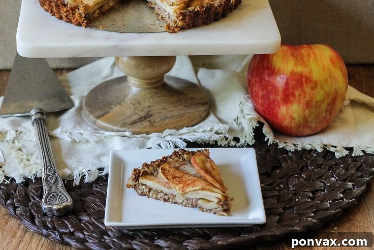Gluten-Free Vegan Rustic Spiced Apple Tart 3 Thinly sliced spiced apples ready for baking in a healthy gluten-free and vegan oatmeal-almond crust tart, perfect for any occasion.