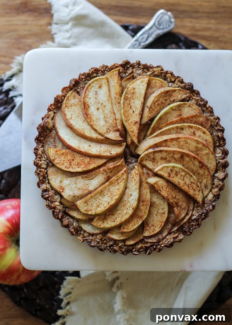 Gluten-Free Vegan Rustic Spiced Apple Tart 5 A full Spiced Apple Tart cooling on a wire rack, ready to be sliced and served, highlighting its rustic charm and inviting texture.