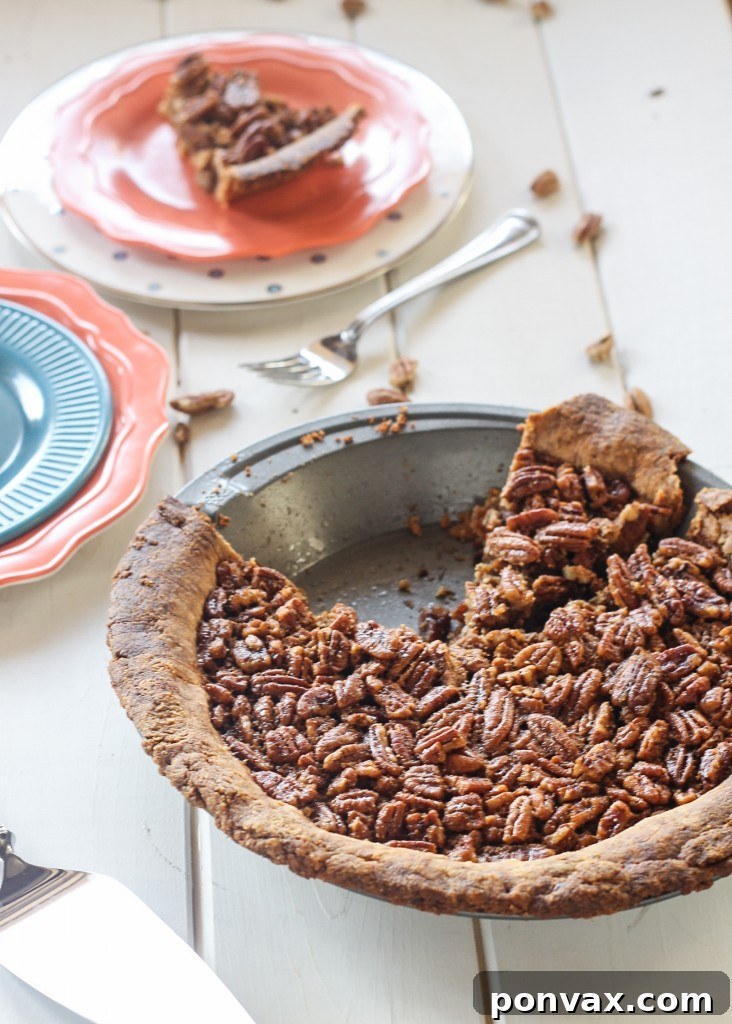 Grain-Free Pecan Pie Perfection 2 A slice of Paleo Pecan Pie with a perfectly set, rich filling and a golden, flaky crust. A top-rated healthy holiday dessert.