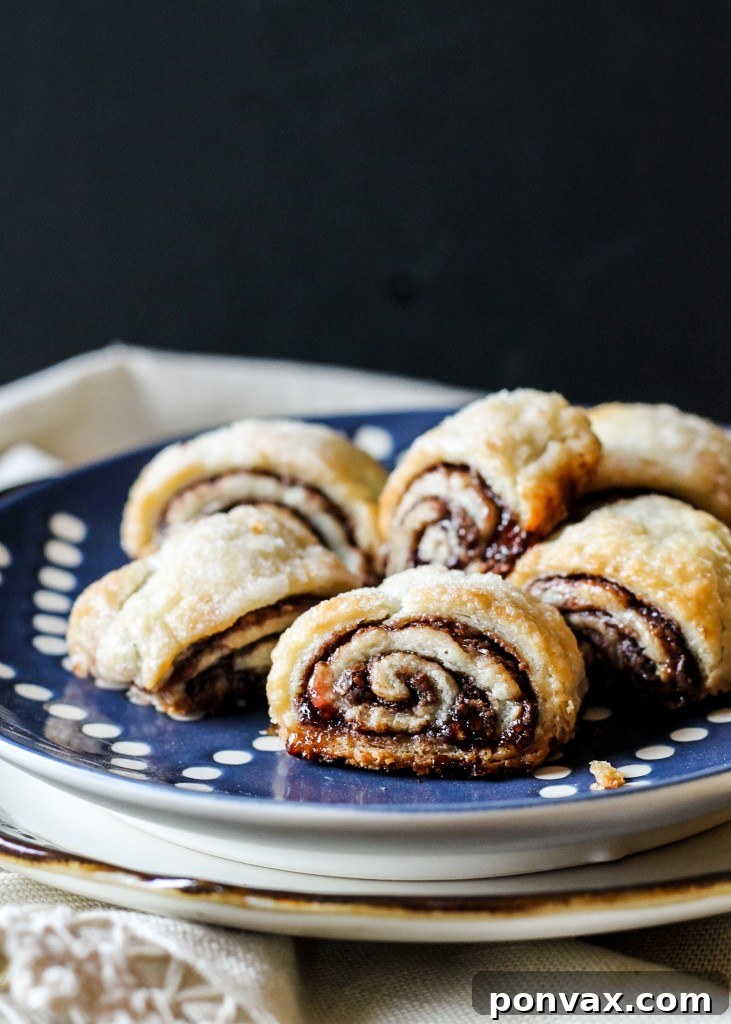 These flaky, melt-in-your-mouth Nutella Raspberry Rugelach are almost too easy to eat - they'll disappear before your eyes! They also keep incredibly well in the freezer.