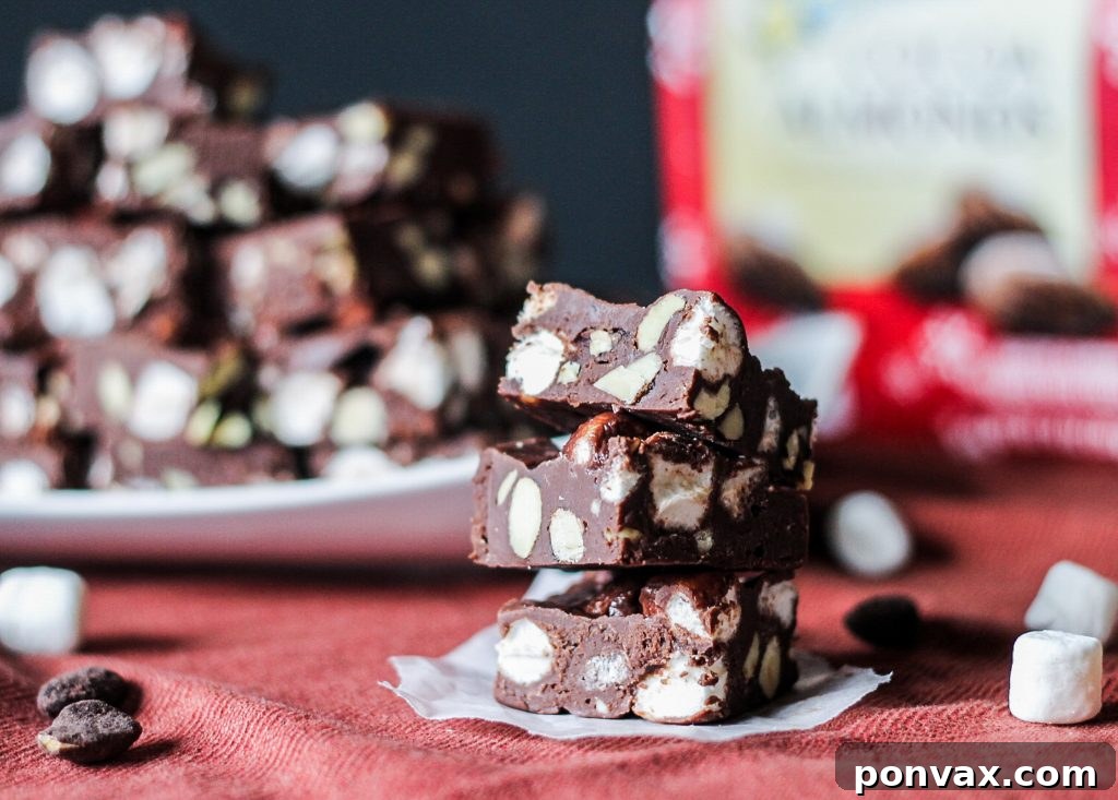 Rich, creamy Easy Rocky Road Fudge with a sprinkle of chocolate chips, marshmallows, and chopped almonds.