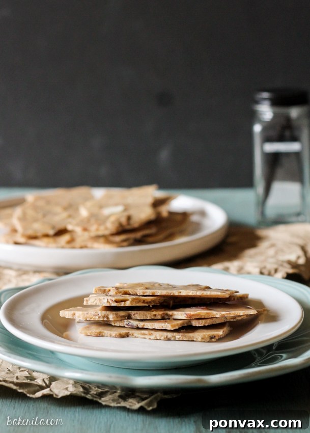 A close-up of a homemade Vanilla Almond Butter Bark with visible almond pieces, highlighting its crunchy and creamy texture.