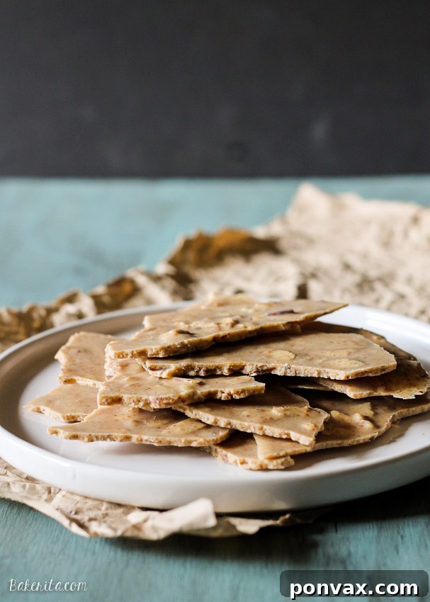 Several pieces of Vanilla Almond Butter Bark arranged artfully, ready to be enjoyed as a healthy snack or dessert.