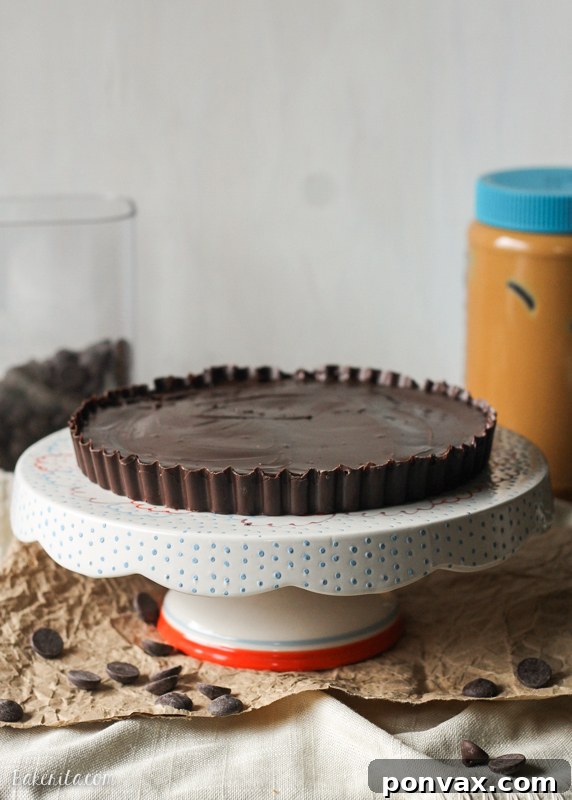 The impressive size of the XL Peanut Butter Cookie Dough Cup, showcasing its thick chocolate shell and generous cookie dough filling.