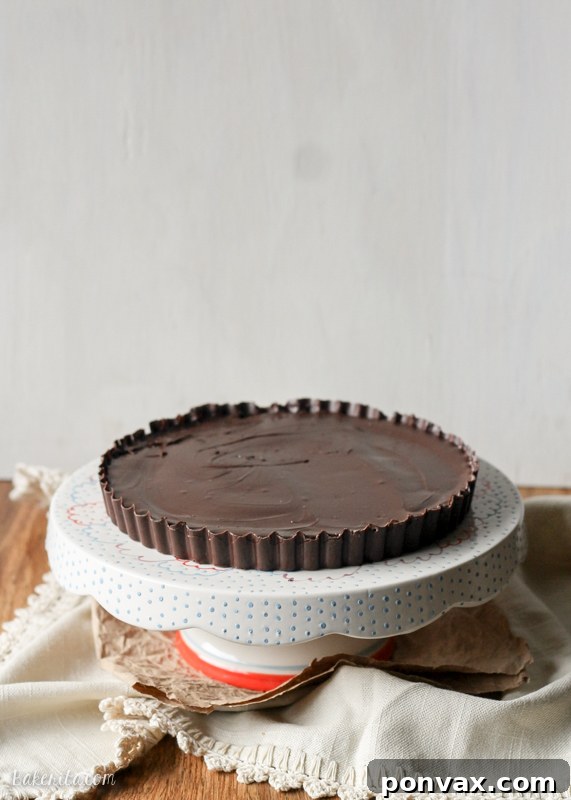 A slice of the XL Peanut Butter Cookie Dough Cup, revealing the thick layers of chocolate and the creamy, decadent peanut butter cookie dough.