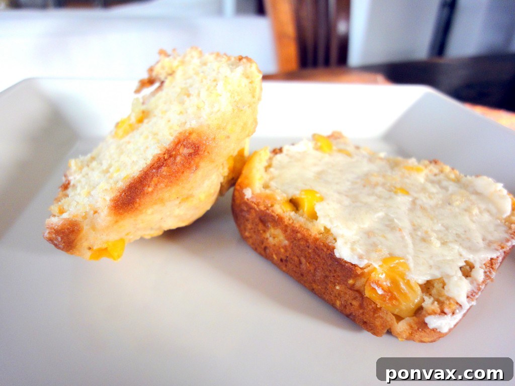 Freshly Baked Corn Muffins Golden-brown corn muffins, fresh out of the oven, with a scattering of corn kernels visible