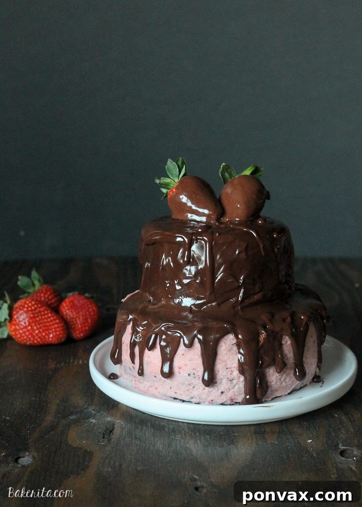 Rich mini chocolate strawberry layer cake with chocolate ganache drip