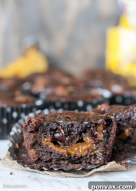 Decadent Chocolate Banana Muffins with Caramel Cores 2 Deliciously moist Caramel Filled Chocolate Banana Bread Muffins bursting with gooey caramel centers and chocolate chips.