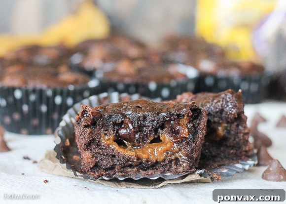 Decadent Chocolate Banana Muffins with Caramel Cores 5 A delicious Caramel Filled Chocolate Banana Bread Muffin cut in half to show the gooey caramel center.
