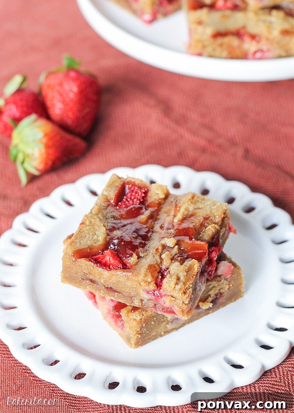 Delicious Peanut Butter & Jelly Bars with strawberry swirls, perfect for a nostalgic treat.