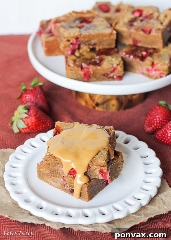Close-up of freshly baked Peanut Butter & Jelly Bars, showcasing the beautiful strawberry jam swirls.