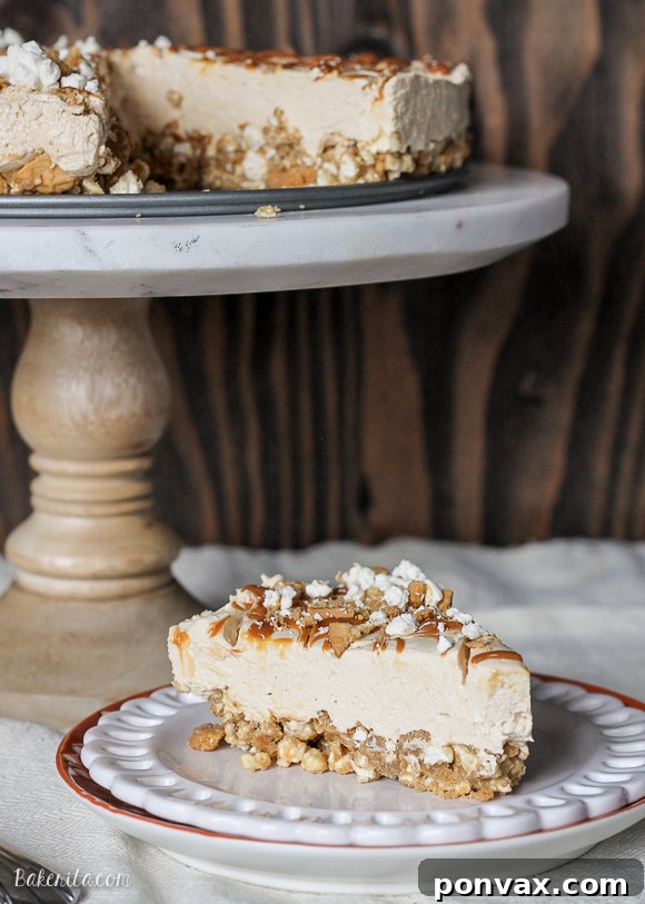 Close-up shot of the No-Bake Peanut Butter Dulce de Leche Cheesecake, showcasing the intricate texture of the popcorn and Nutter Butter crust before the filling is added. The image emphasizes the rustic yet inviting base of this unique dessert, promising a delightful crunch.