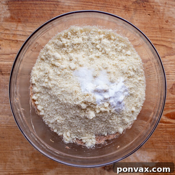 Irresistible Paleo Chocolate Chip Cookies Vegan Friendly 11 Almond flour, baking soda, and salt being added to the wet ingredients.