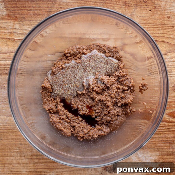 Irresistible Paleo Chocolate Chip Cookies Vegan Friendly 9 Flax egg and vanilla extract being added to the creamed mixture.